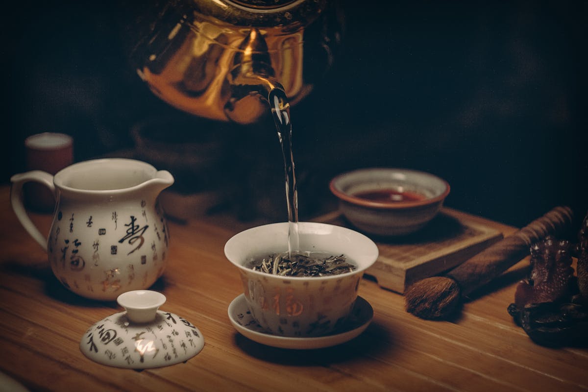 Green tea steeping in clear glassware