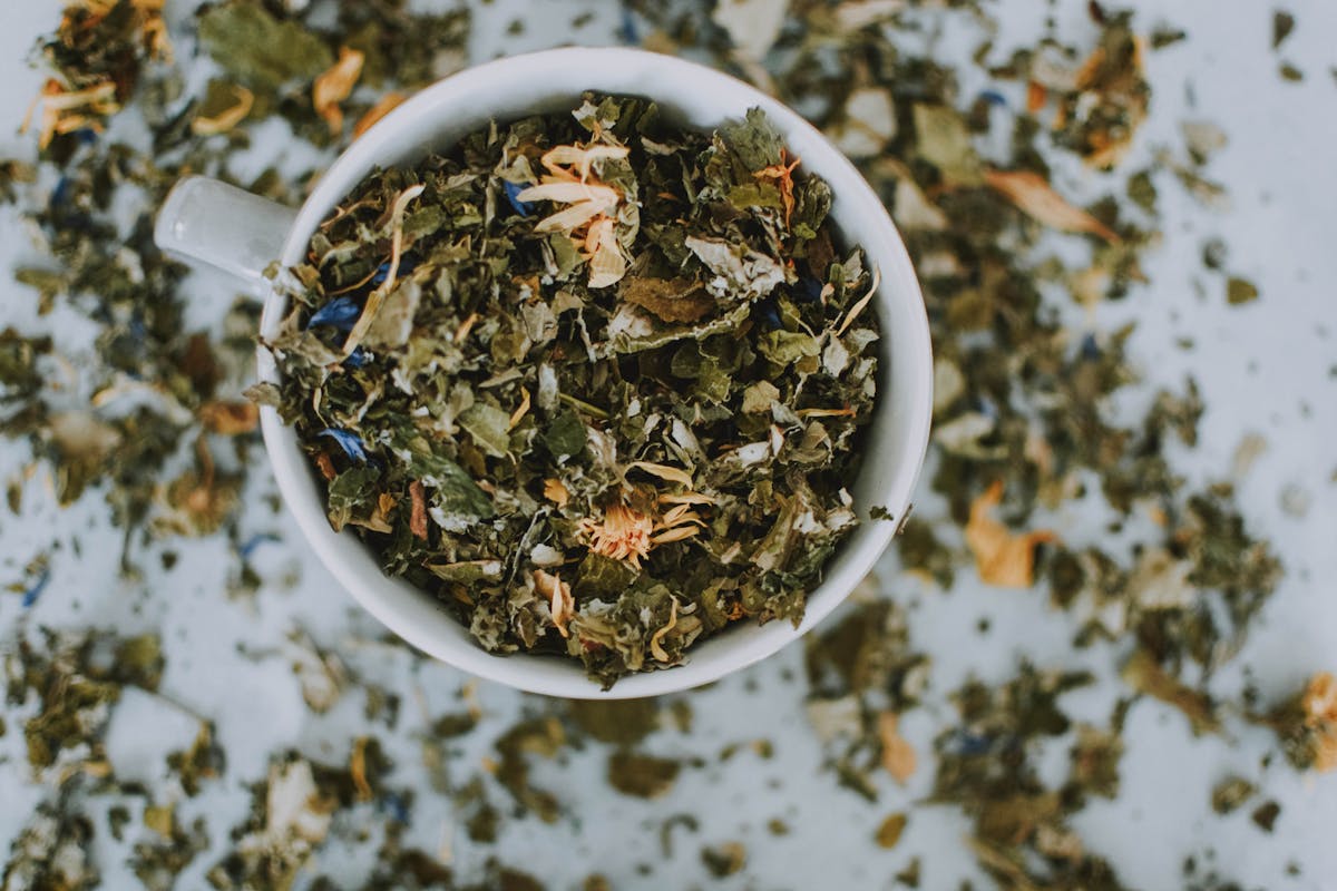 Herbal infusion with dried flowers on a calm tabletop